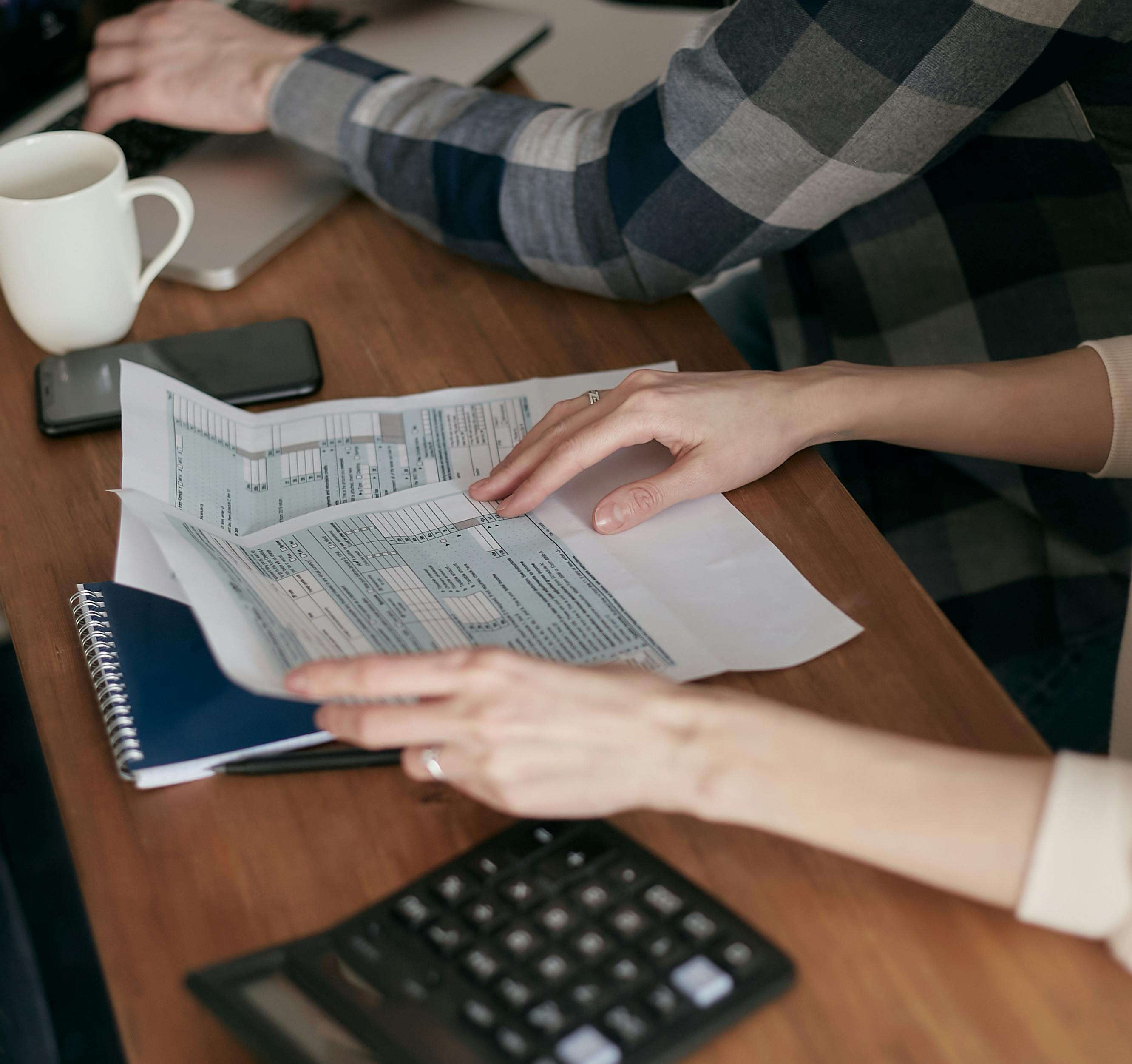 A client reviewing financial and tax planning documents at a desk